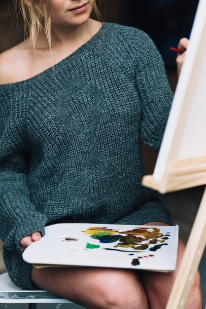 Artistic woman with watercolor and canvas