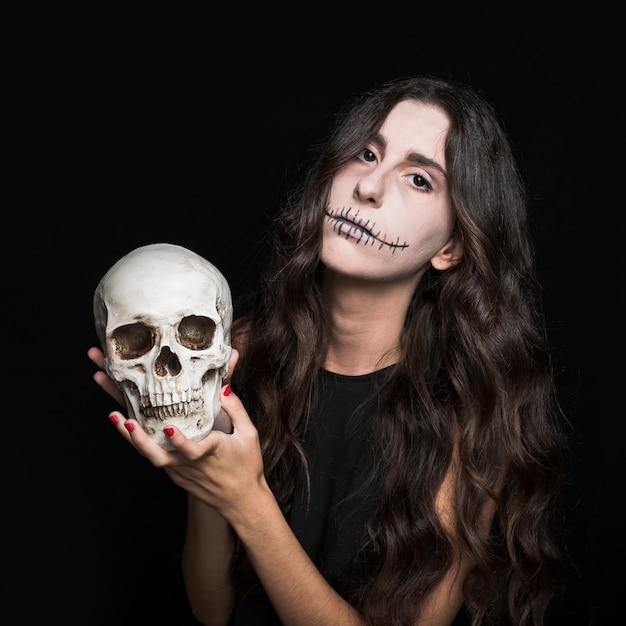 Ashy woman holding skull