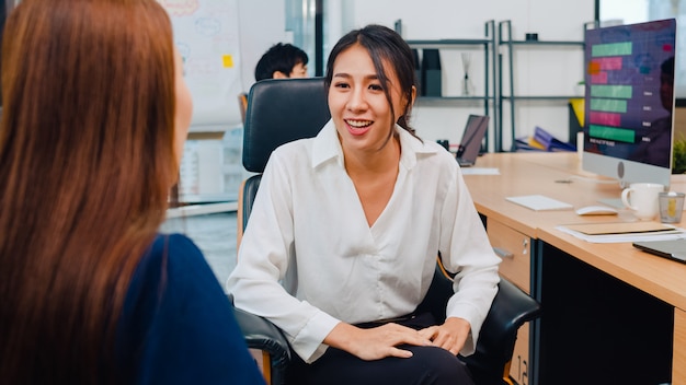 Asia businesspeople chatting to intern discussing job interview colleagues having conversation and communication meeting brainstorming ideas about project working plan success strategy in office.