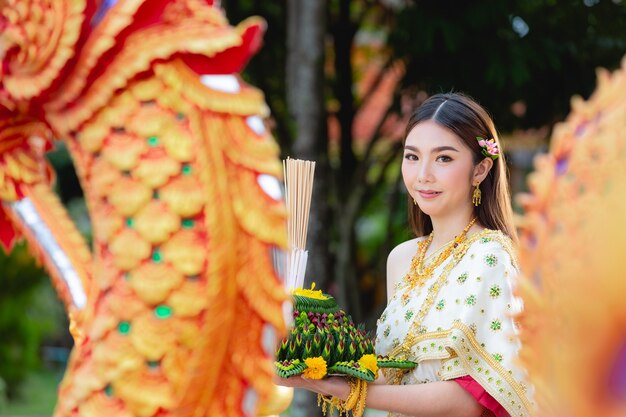 Asia woman in Thai dress traditional hold kratong Loy krathong festival