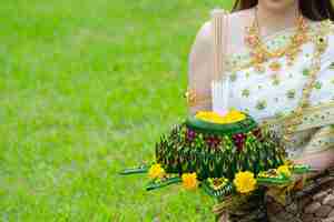 Free photo asia woman in thai dress traditional hold kratong loy krathong festival