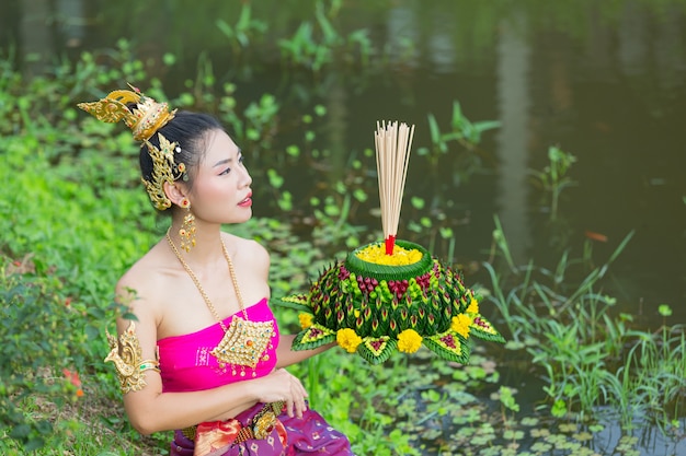 Asia woman in Thai dress traditional hold kratong. Loy krathong festival