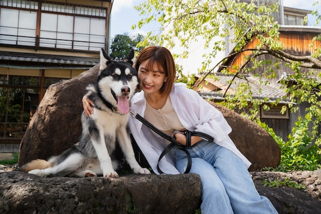 Asia woman walking her husky dog outdoors