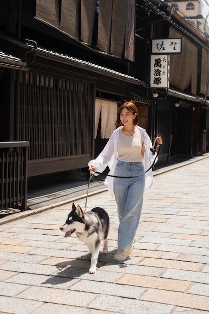 Asia woman walking her husky dog outdoors