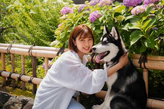 Free photo asia woman walking her husky dog outdoors