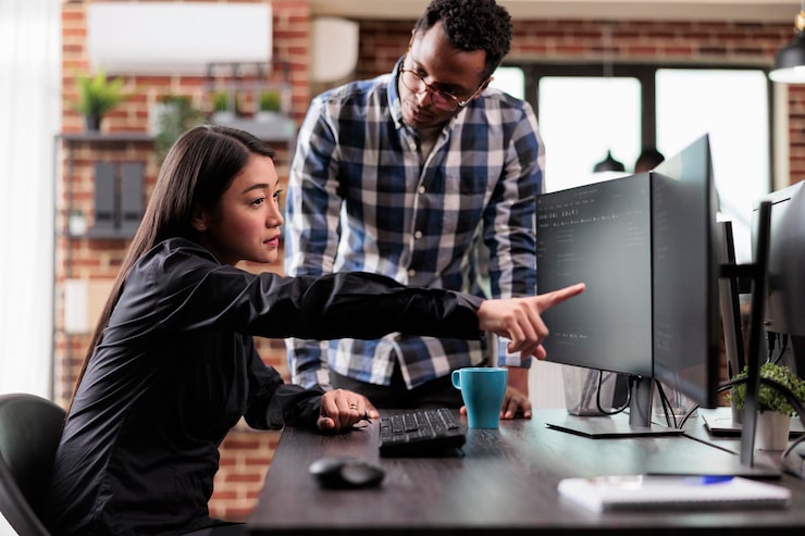 Free Photo asian application developer pointing out cloud database processing algorithm error while uploading network information. multiethnic tech software engineers decrypting retrieved stolen data.