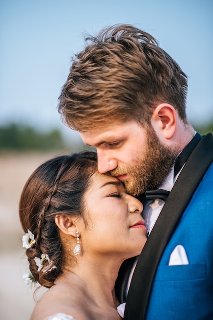 Asian bride and Caucasian groom have romance time and happy together 