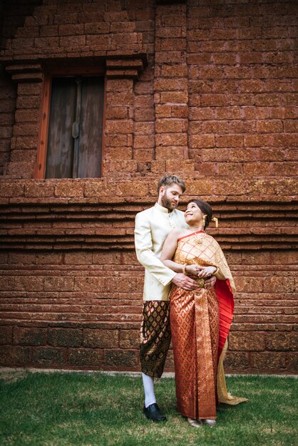 Asian bride and Caucasian groom have romantic time with Thailand dress