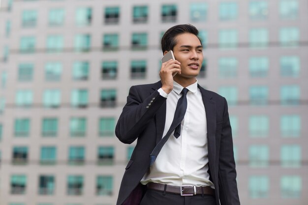 Asian Business Man Talking on Phone Outside