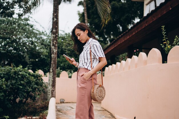 Asian business woman on a vacation talking on phone