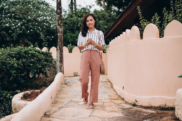 Asian business woman on a vacation talking on phone