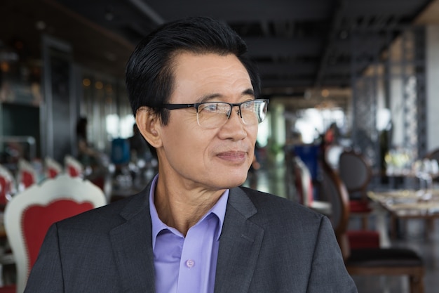 Asian Businessman Sitting in Restaurant