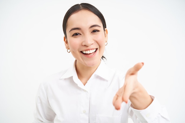 Free photo asian businesswoman extends hand for handshake team leader introduces herself and smiles friendly st