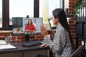 Asian businesswoman waving at webcam videocall digital conference with general manager talking about business financial issue. asian accountant informing superior about failed startup.