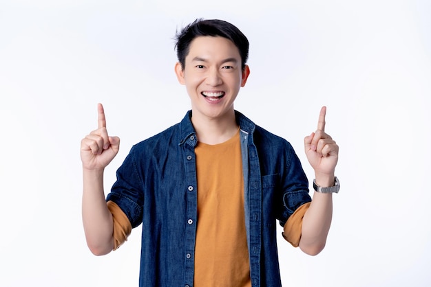 Asian cheerful glasses male casual dress smaile laugh gesture hand point finger to copyspace for your creativity ideas text white background