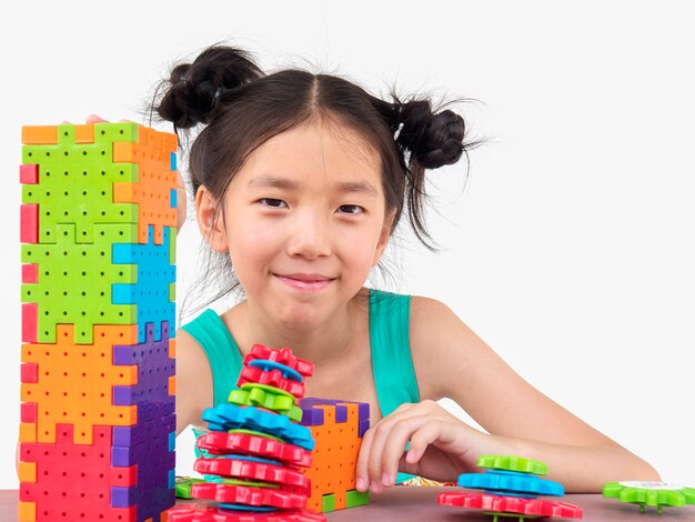 Asian children are playing puzzle plastic block creative game 