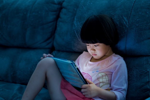 Premium Photo | Asian chinese girl playing smartphone, watching smartphone,  kid use phone and play game, child use mobile, addicted game and cartoon