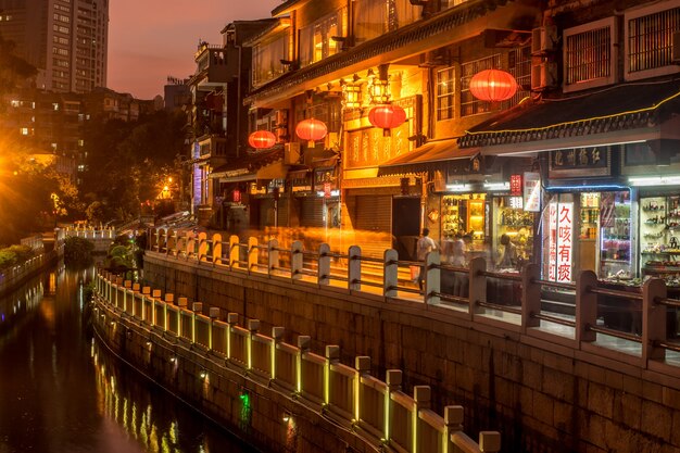 Asian city with chinese lanterns and a river