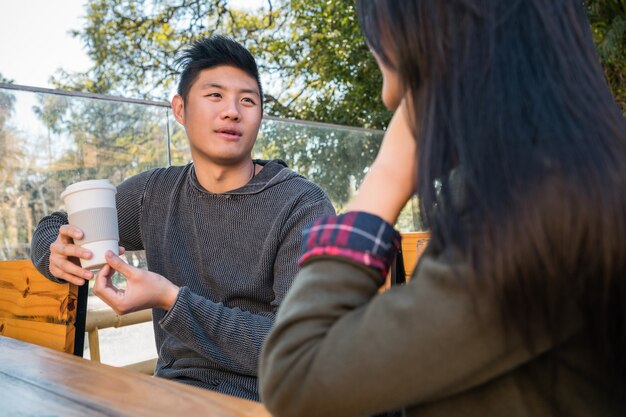 Asian couple at coffee shop.