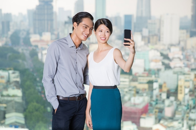 Asian Couple Taking Selfie Photo with Smartphone