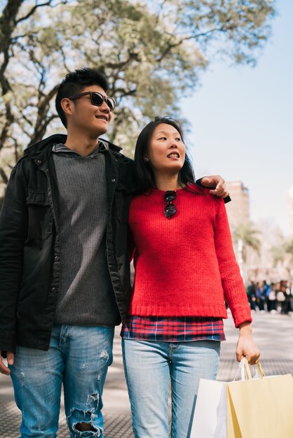 Asian couple walking in the city.