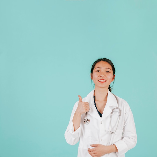 Asian doctor gesturing thumb-up