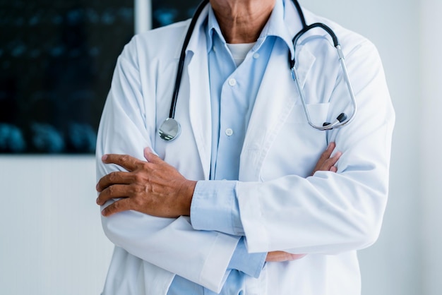 Asian doctor standing with confident hospital background health ideas concept
