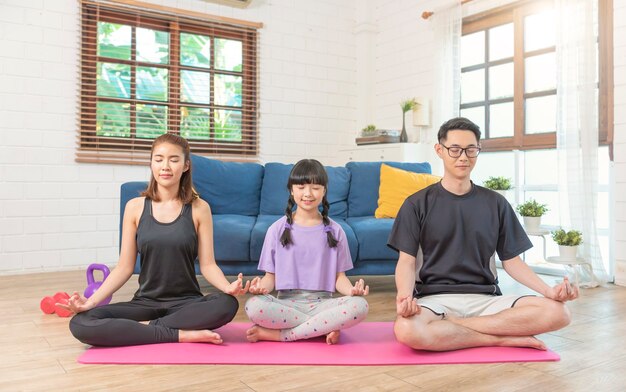 Asian family healthy meditation workout at home, exercise, fit, doing yoga. home sport fitness concept