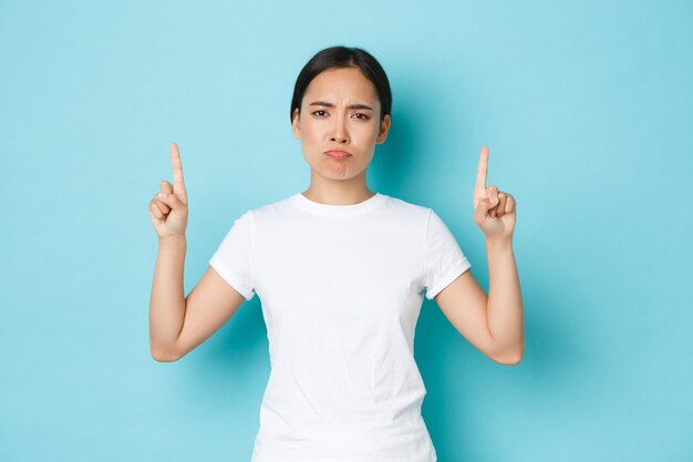 Asian female in casual T-shirt posing