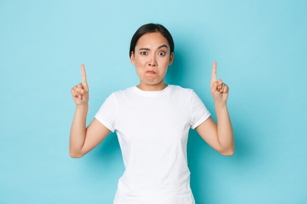 Asian female in casual T-shirt posing