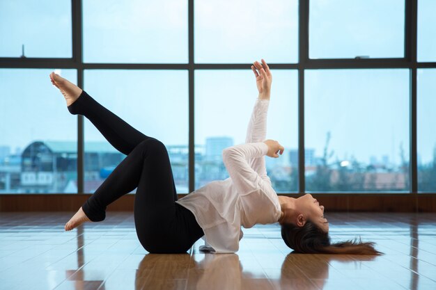 Asian female lying on floor while dancing