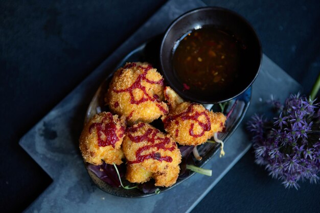 Asian fried vegetables with sauce on dark background Closeup