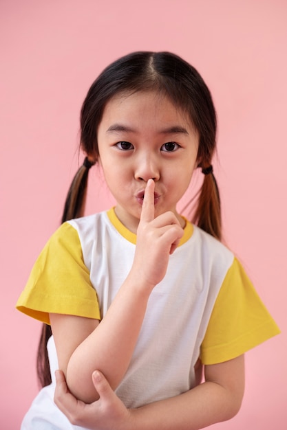 Asian girl asking for silence