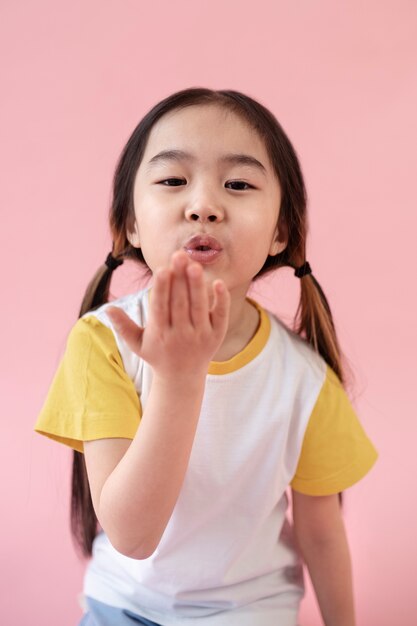 Asian girl blowing a kiss