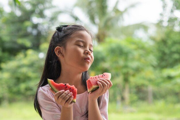 Asian girl eating watermelon