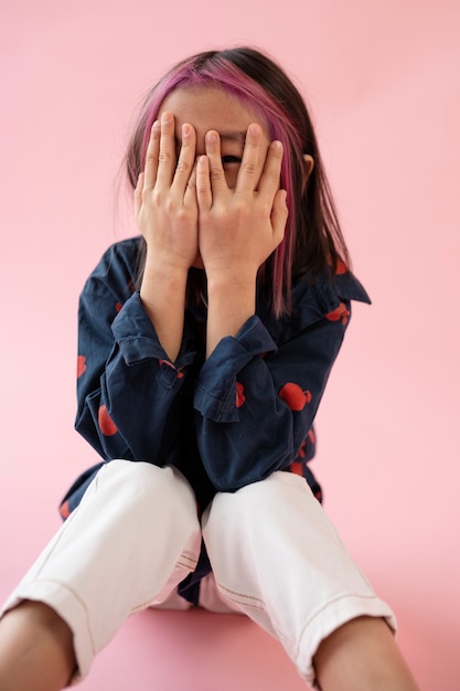 Asian girl looking through her fingers