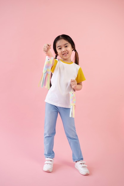 Asian girl showing paper fishes