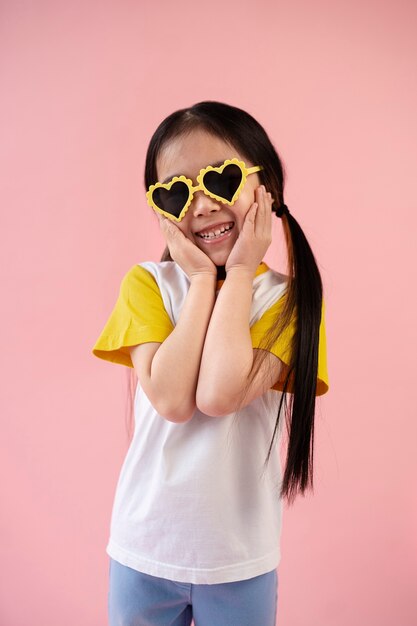 Asian girl smiling with heart-shaped sunglasses