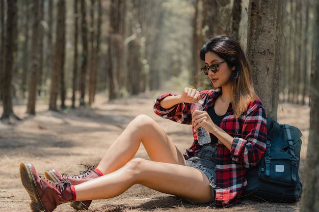 Asian hiker woman trekking in forest. 