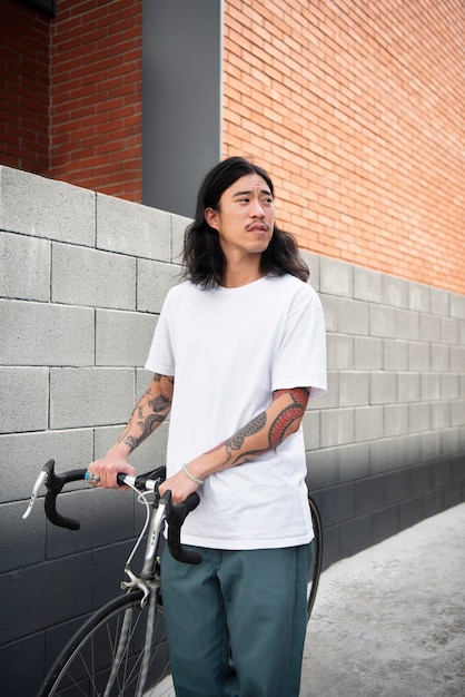 Asian man holding his bike