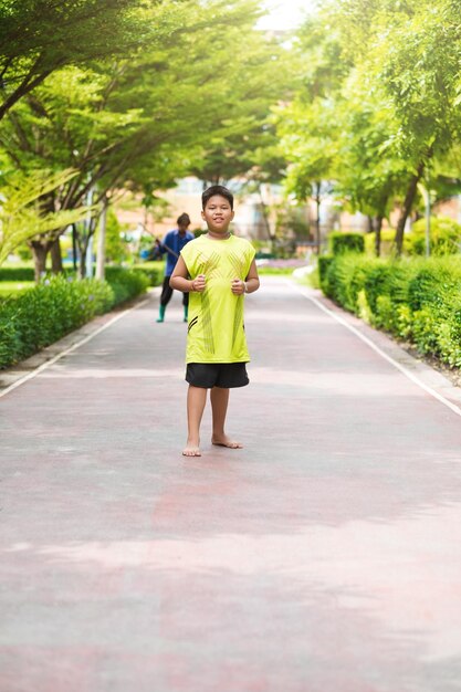 Asian man jogging at the park in sunny morning