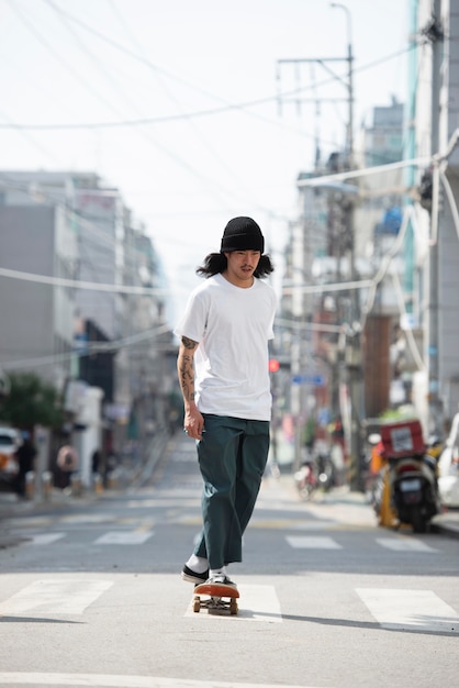 Asian man skateboarding outdoors