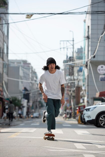 Asian man skateboarding outdoors