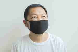 Free photo asian man wearing a black medical mask