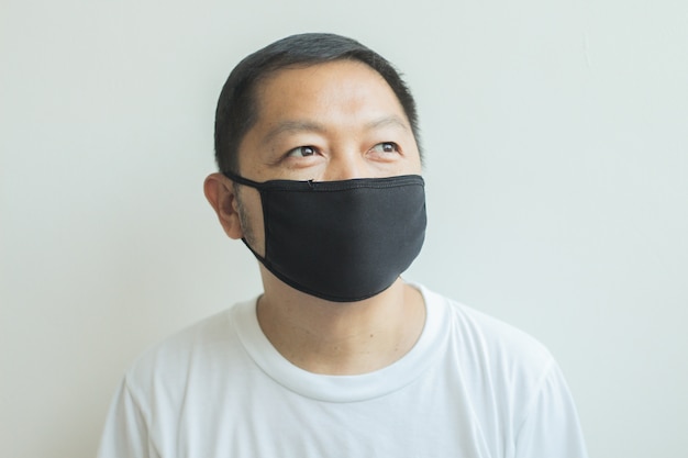 Asian man wearing a black medical mask