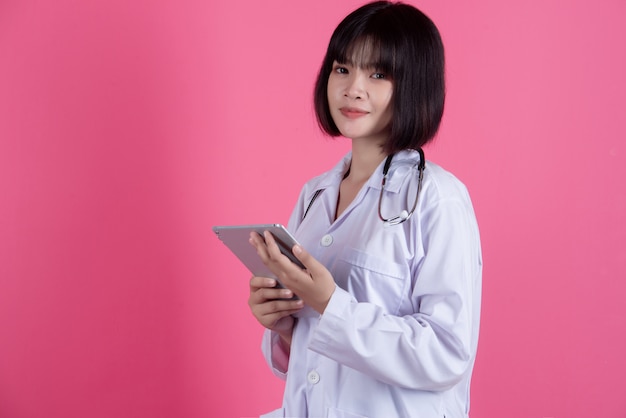 asian medical doctor woman with white lab coat over pink