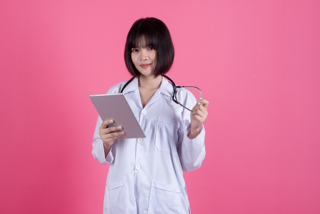 asian medical doctor woman with white lab coat on pink