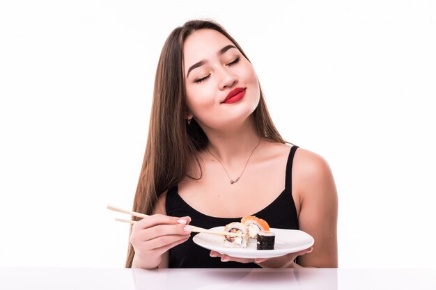 Asian model hold chopsticks with sushi rolls isolated