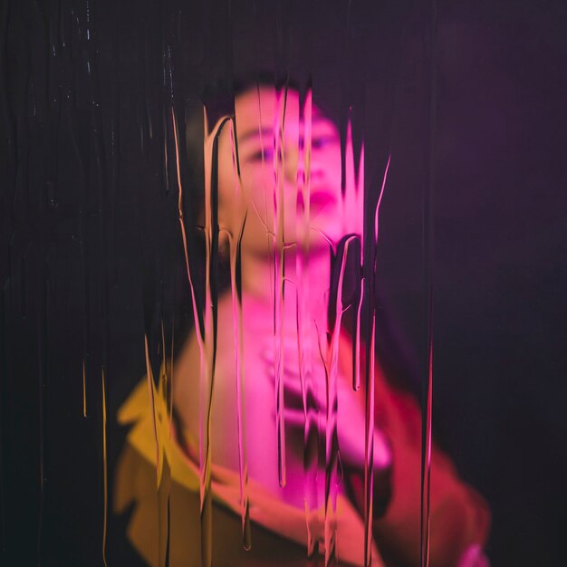 Asian model posing with pink light on her