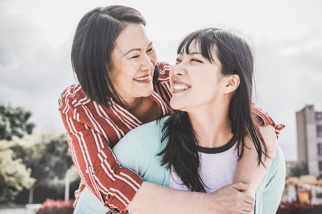 Premium Photo | Asian mother and daughter having fun outdoor - happy family  people enjoying time together around city in asia